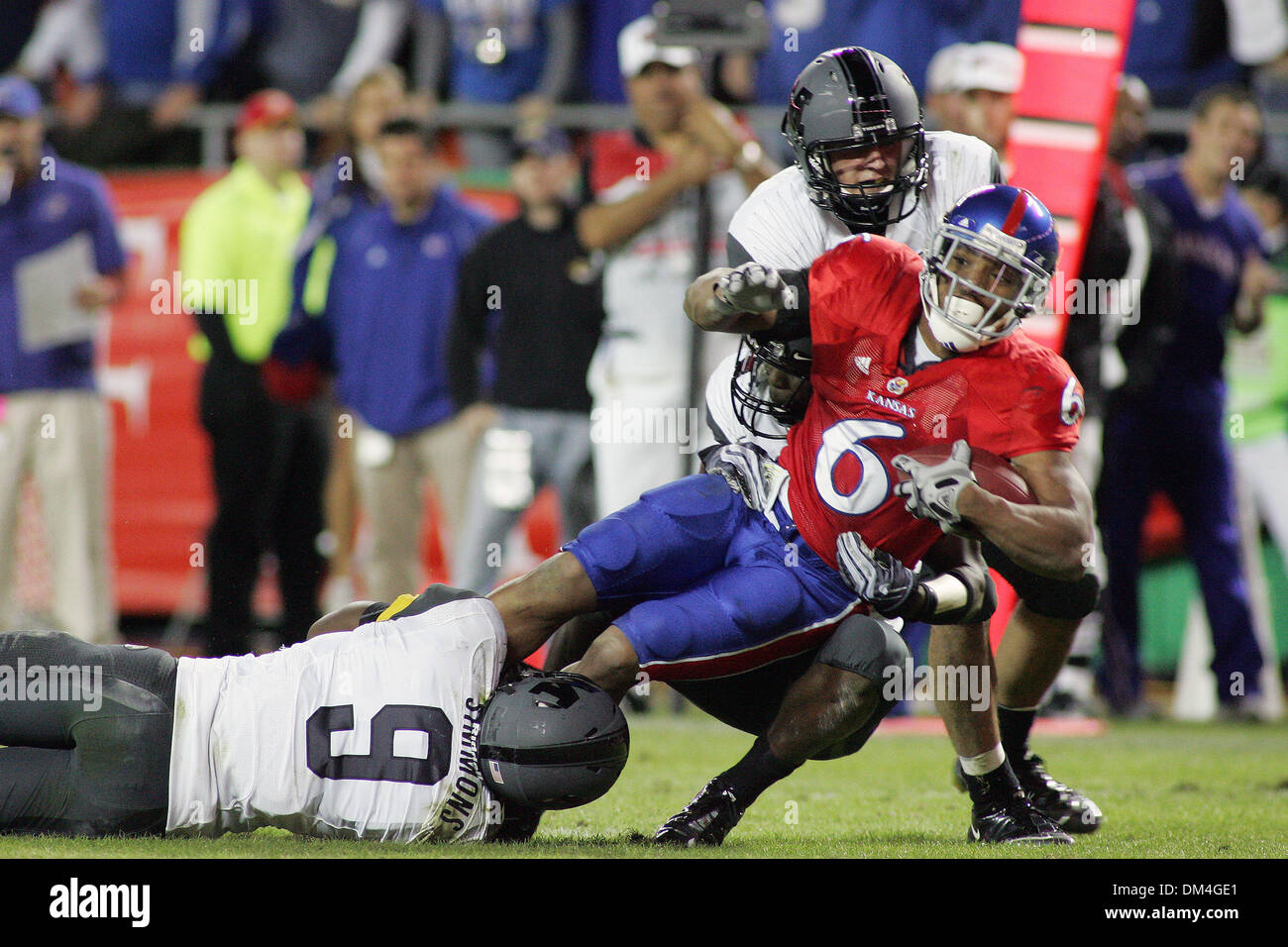 Missouri defensive back Kevin Rutland (20), safety Jasper Simmons (9), and linebacker Andrew Gachkar (6) take down Kansas running back Rell Lewis (6) during second half action in the game between the Kansas Jayhawks and the Missouri Tigers being played at Arrowhead Stadium in Kansas CIty, Missouri.  Missouri beat Kansas 41-39. (Credit Image: © Jacob Paulsen/Southcreek Global/ZUMApr Stock Photo