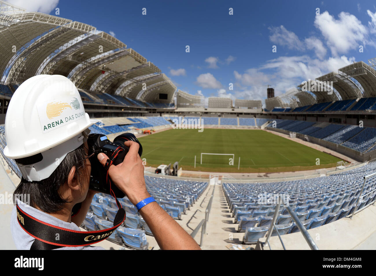 Natal, Brazil. 08th Dec, 2013. A journalist takes a picture during a tour of the 'Arena das Dunas' in Natal, Brazil, 08 December 2013. Photo: MARCUS BRANDT/dpa/Alamy Live News Stock Photo