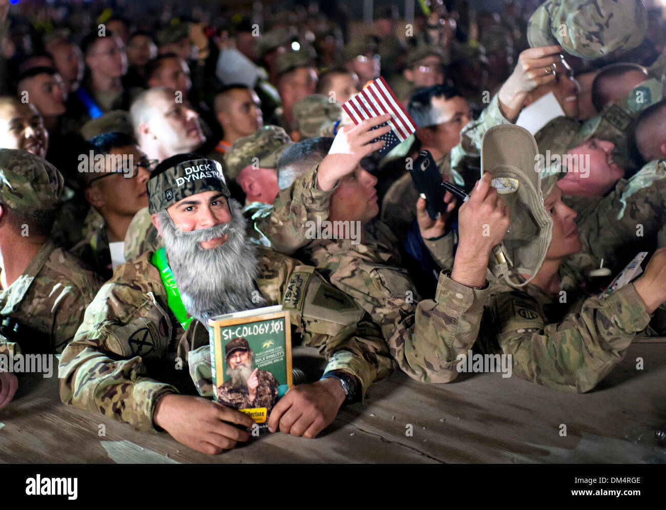 Camp Leatherneck, Helmand, Afghanistan. 10th December 2013. A US Army soldier wearing a fake beard waits for Duck Dynasty reality television star Willie Robertson December 10, 2013 at Kandahar Airfield, Kandahar province, Afghanistan. The visit was part of the USO Holiday Tour. Credit:  Planetpix/Alamy Live News Stock Photo