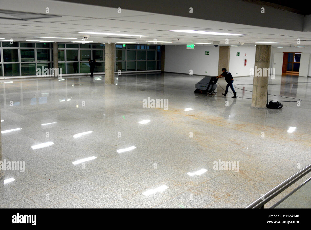 Cleaners are at work in the lobby area of the 'Stadion Nacional Mane Garrincha' stadium in Brasilia, Brazil, 9 December 2013. The Stadion Nacional Mane Garrincha is one of the venues which will host the matches for the 2014 Soccer World Cup in Brazil. Photo: Marcus Brandt/dpa Stock Photo