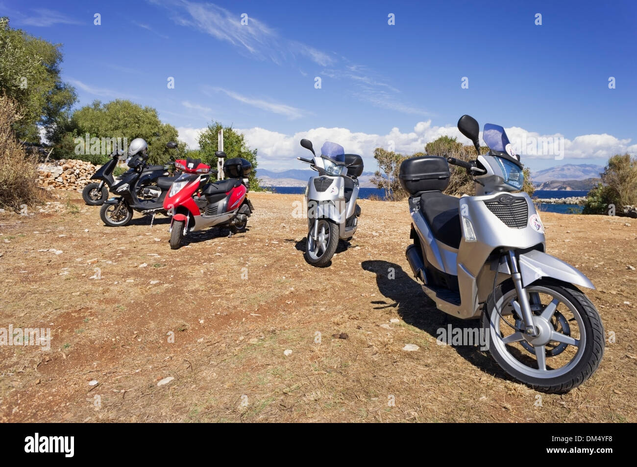 Corfu, Greece holiday rental scooters parked near to a beach Stock