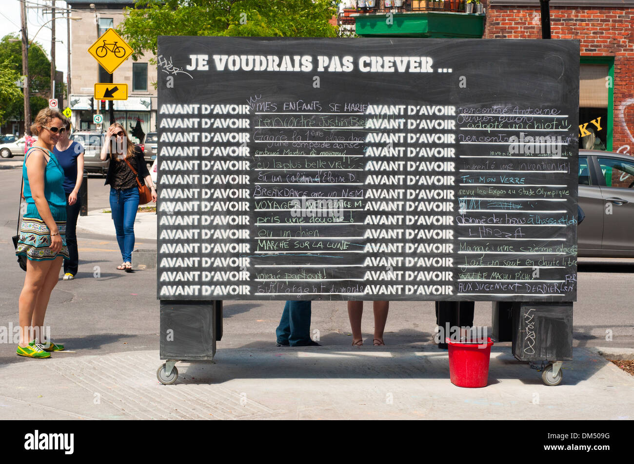 Montrealers write on a street blackboard what they would like to do before dying - a street performance in the Mile End Area Stock Photo