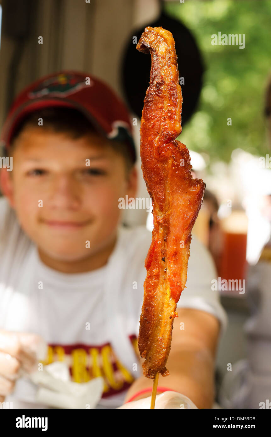 KID SELLING BACON ON A STICK AT THE MINNEOSTA STATE FAIR Stock Photo