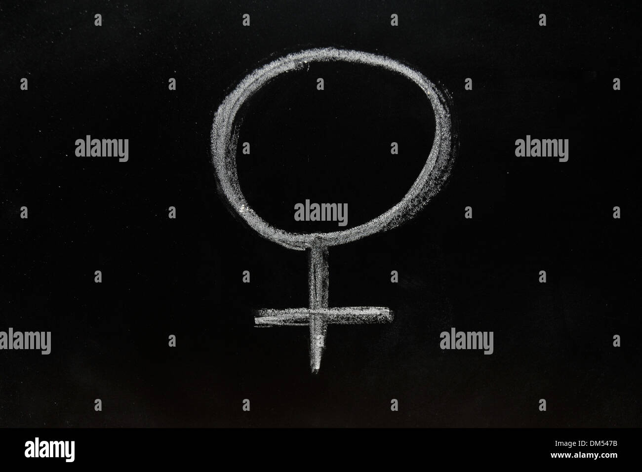 A female gender symbol drawn on a blackboard in chalk. Stock Photo