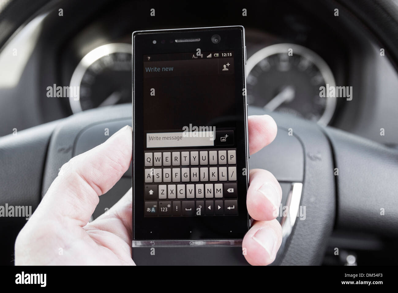 Mobile phone used in motor vehicle for texting Stock Photo