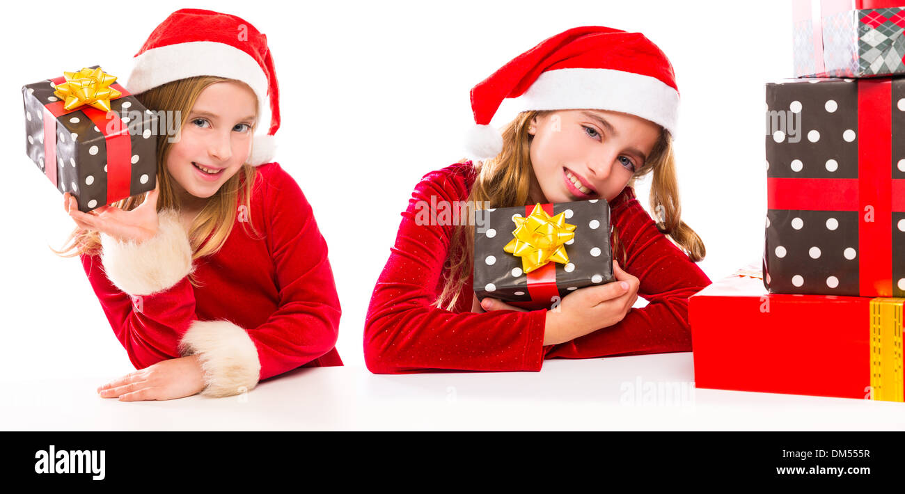 Christmas Santa kid sister girls happy excited with ribbon gifts isolated on white background Stock Photo