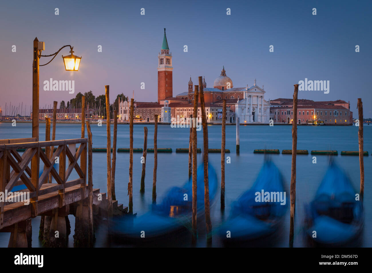 Early morning view of bobbing gondolas with San Giorgio Maggiore beyond, Venice Veneto Italy Stock Photo