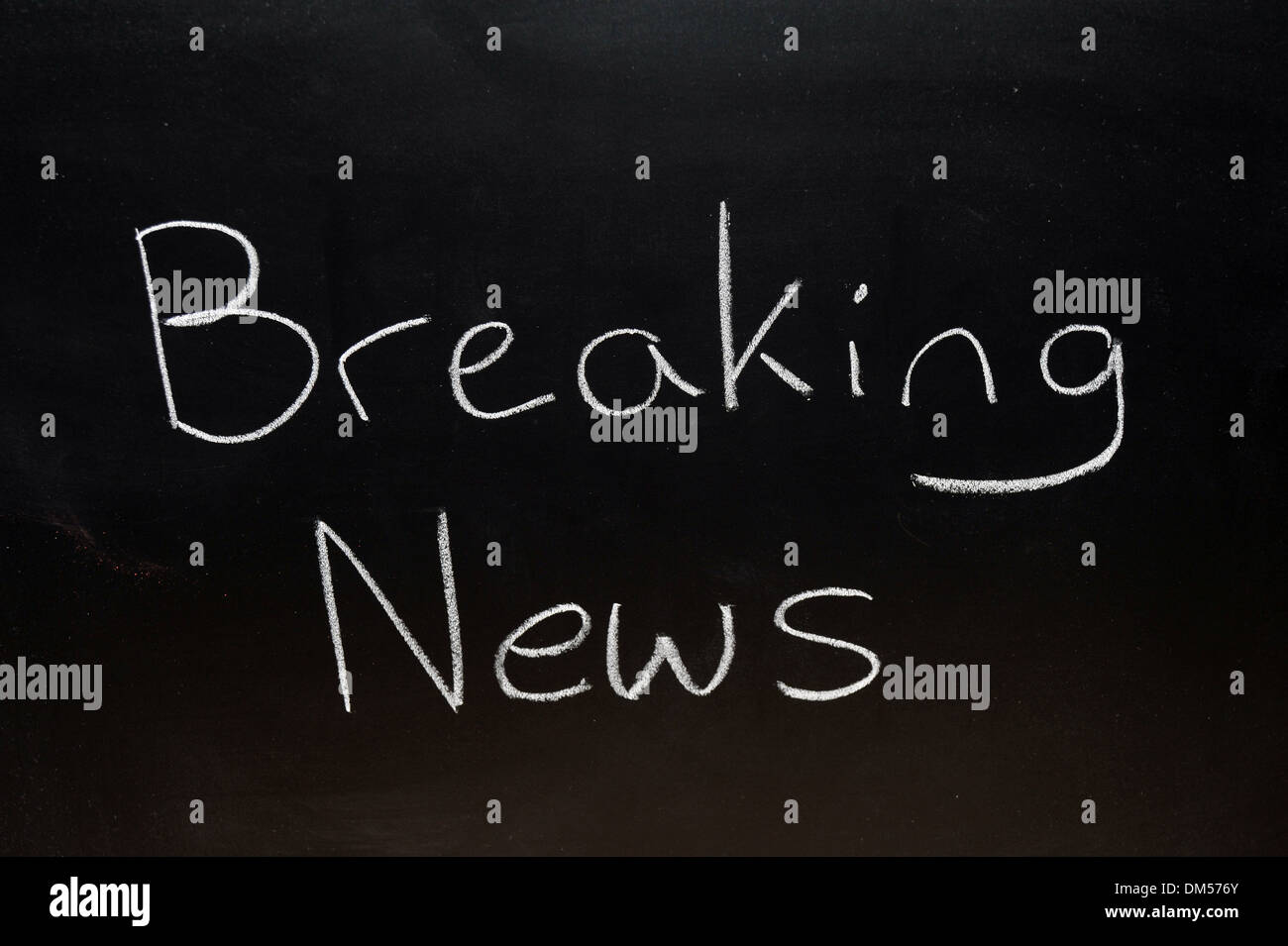 Breaking News drawn on a blackboard in chalk. Stock Photo