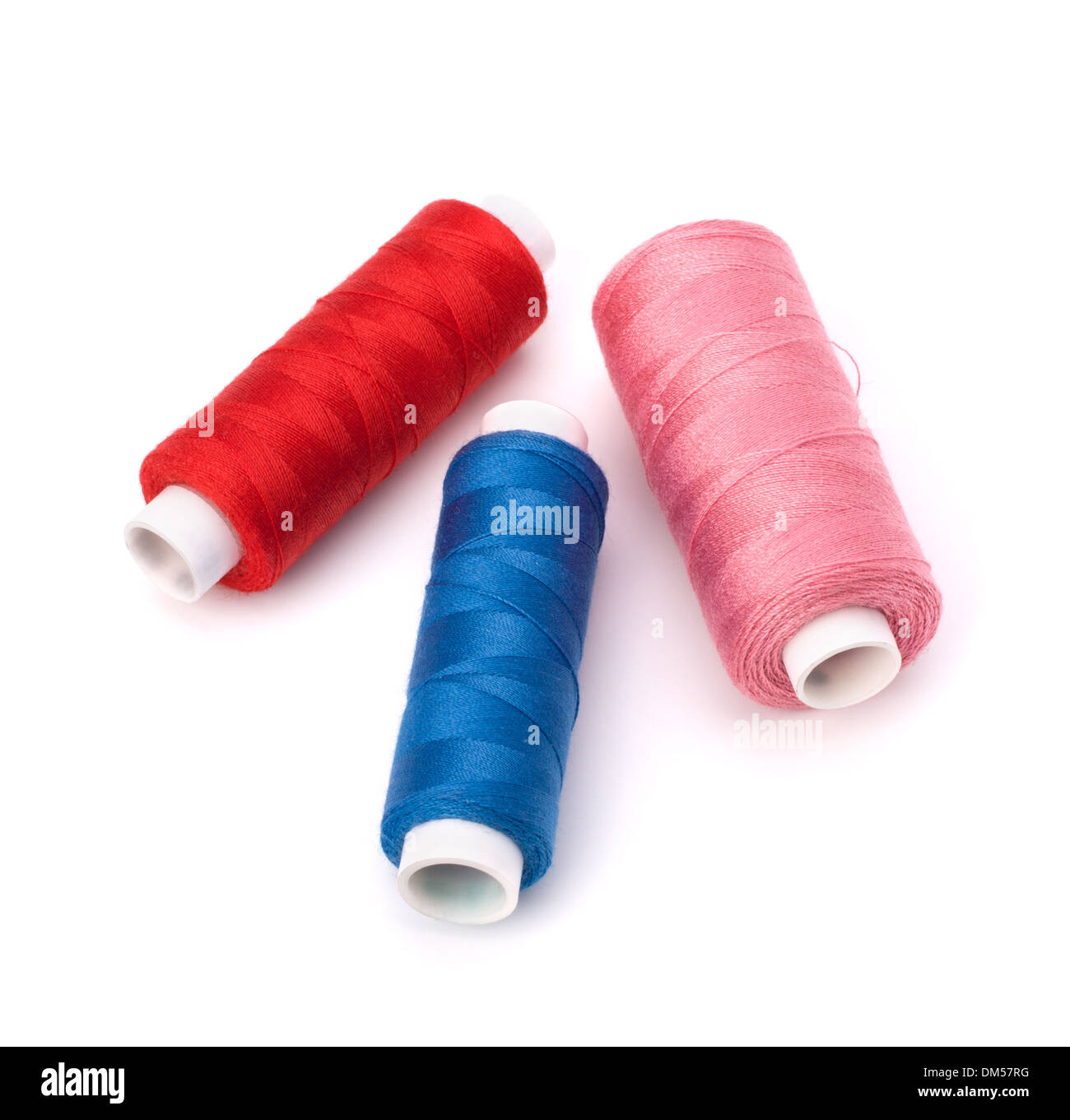 Colourful spools of thread isolated on white background Stock Photo - Alamy