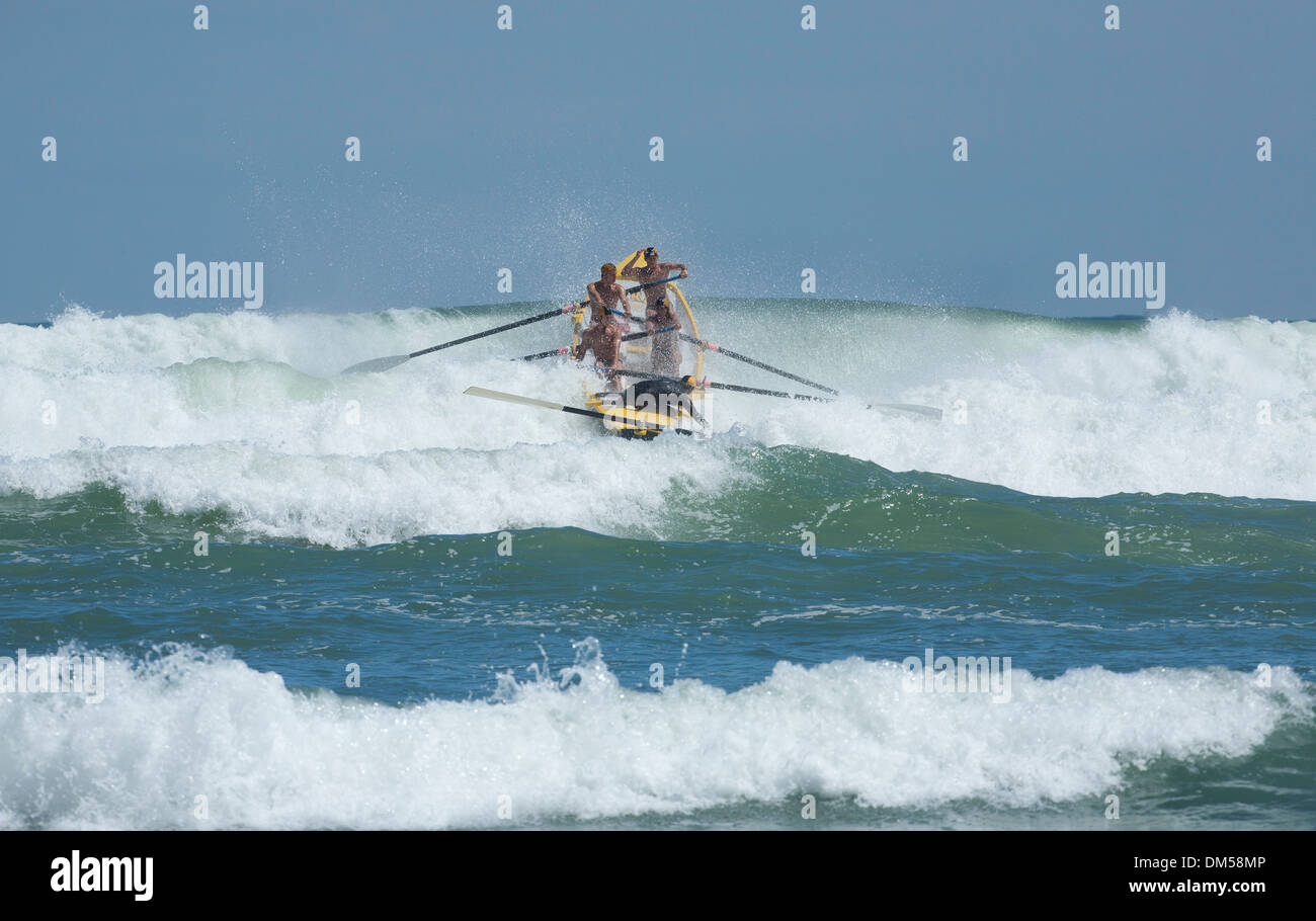 Piha's lifesavers row out to sea in the Piha  Big Wave surf boat competition. Stock Photo