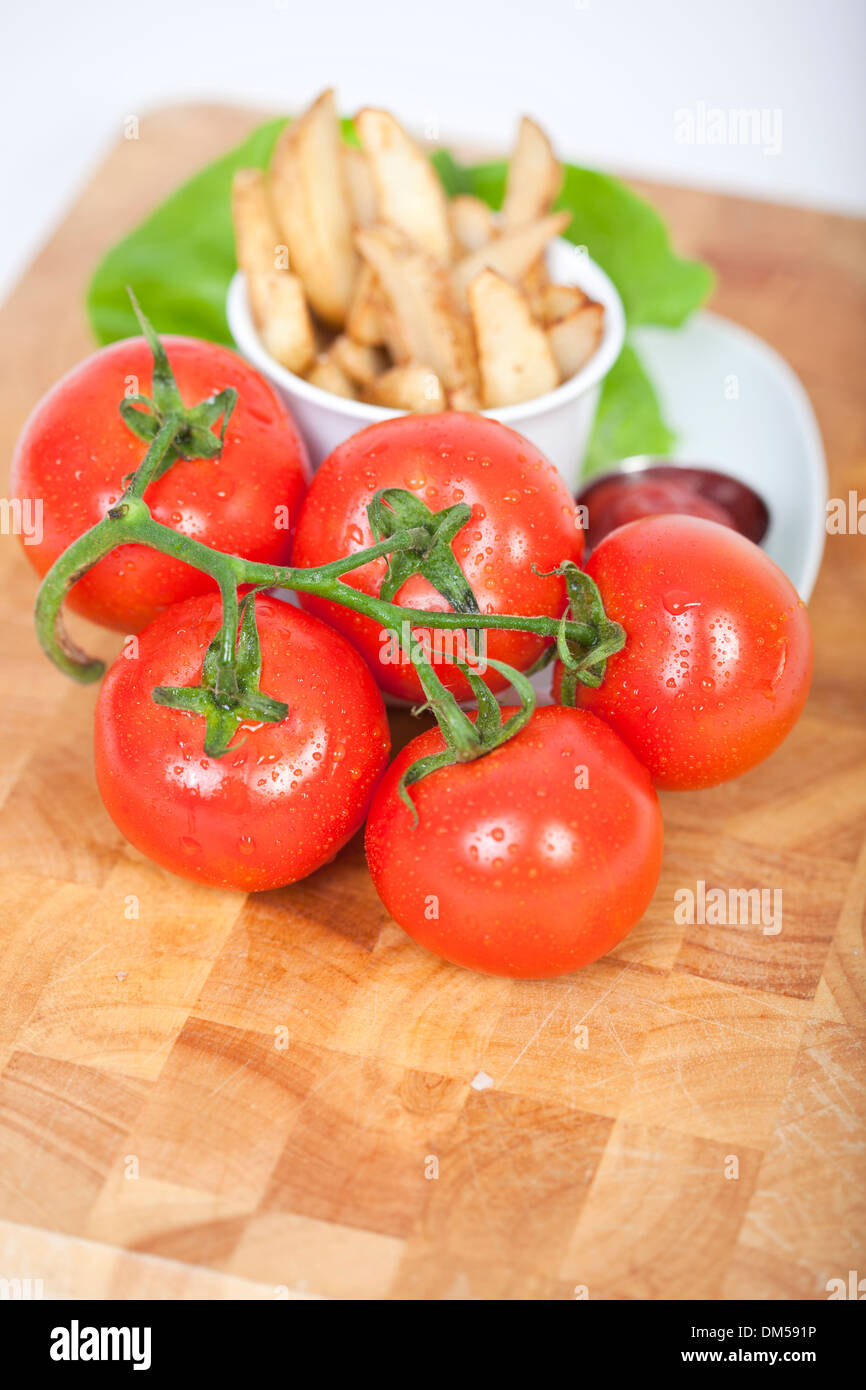 Fresh tomatoes and french fries in a bowl Stock Photo Alamy