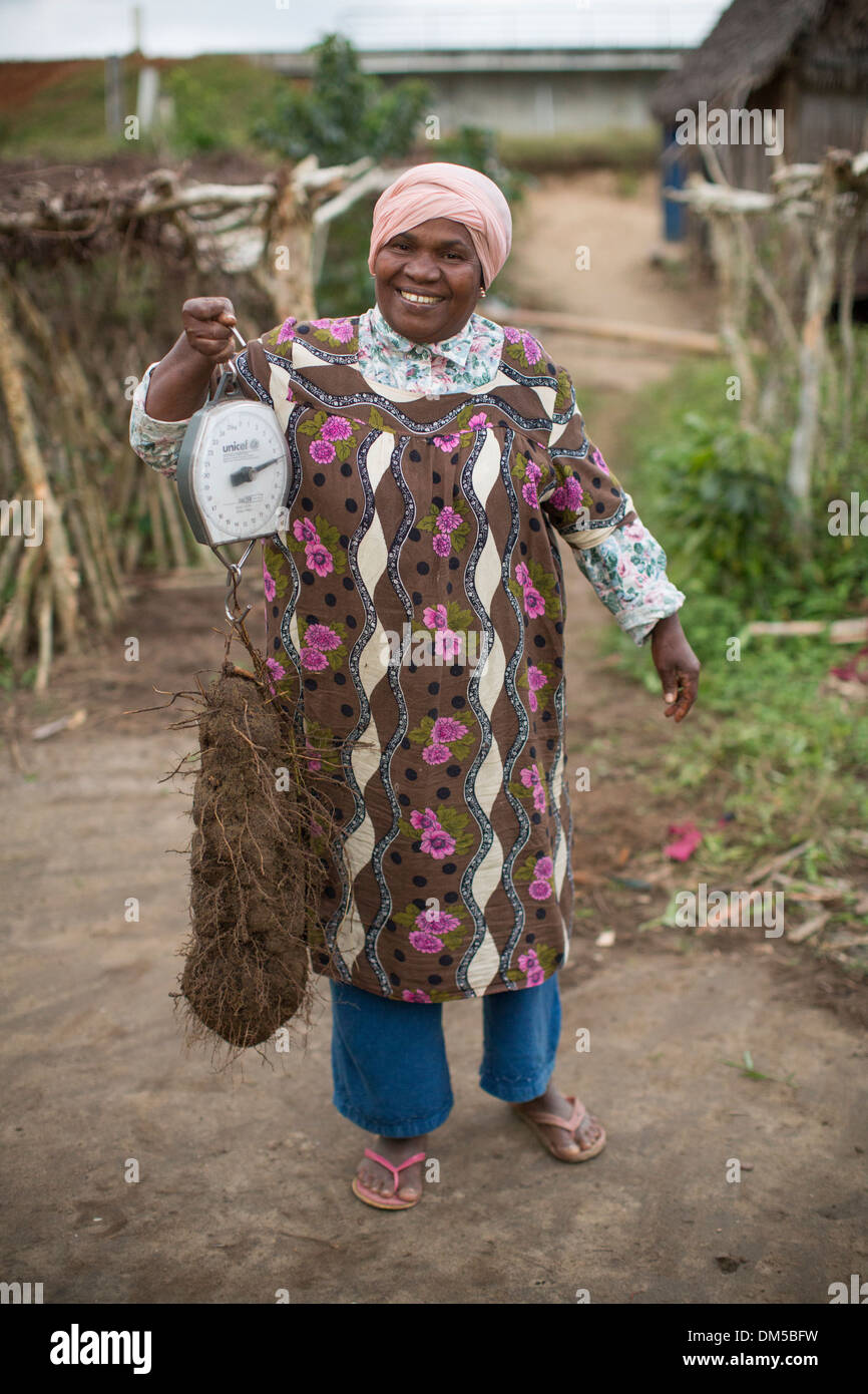 A woman weighs a yam in Atsinanana Region, Madagascar Stock Photo