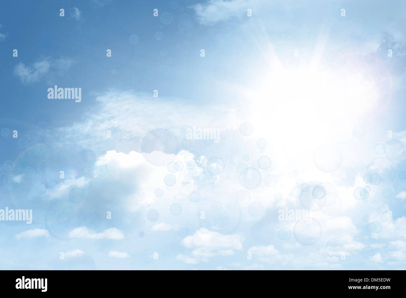 Bright sun shining in clouds Stock Photo
