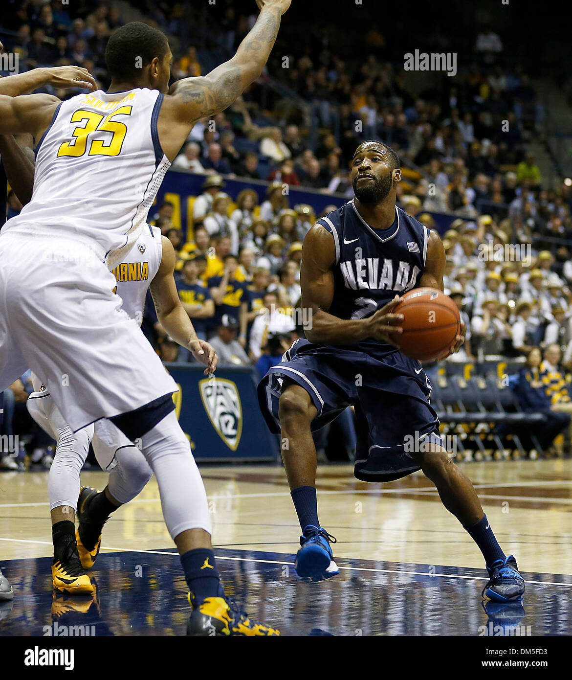 Berkeley, CA, USA. 10th Dec, 2013. Nevada G # 24 Deonte Burton challenge  Cal # 35 Richard Solomon in the paint and score during NCAA Mens Basketball  game between University of Nevada