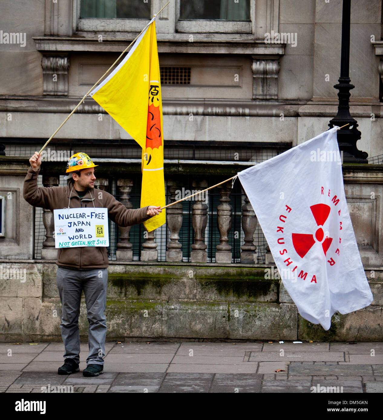LONDON - DEC 21: An anti nuclear protester for the Fukushima Daiichi disaster stands outside the Japanese London embassy in the United Kingdom Stock Photo