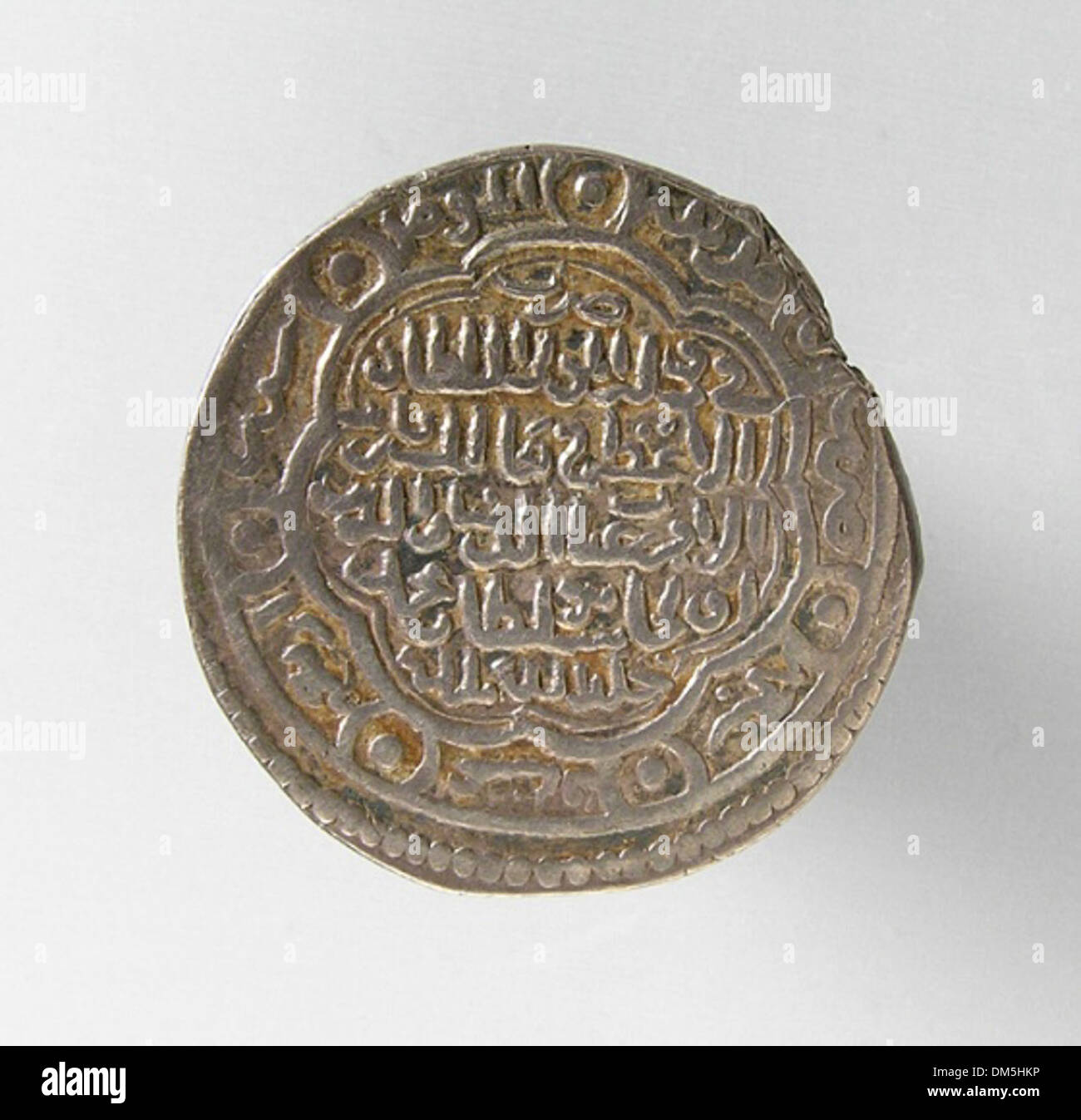 This dirham, a silver coin minted in the Islamic world, features ...