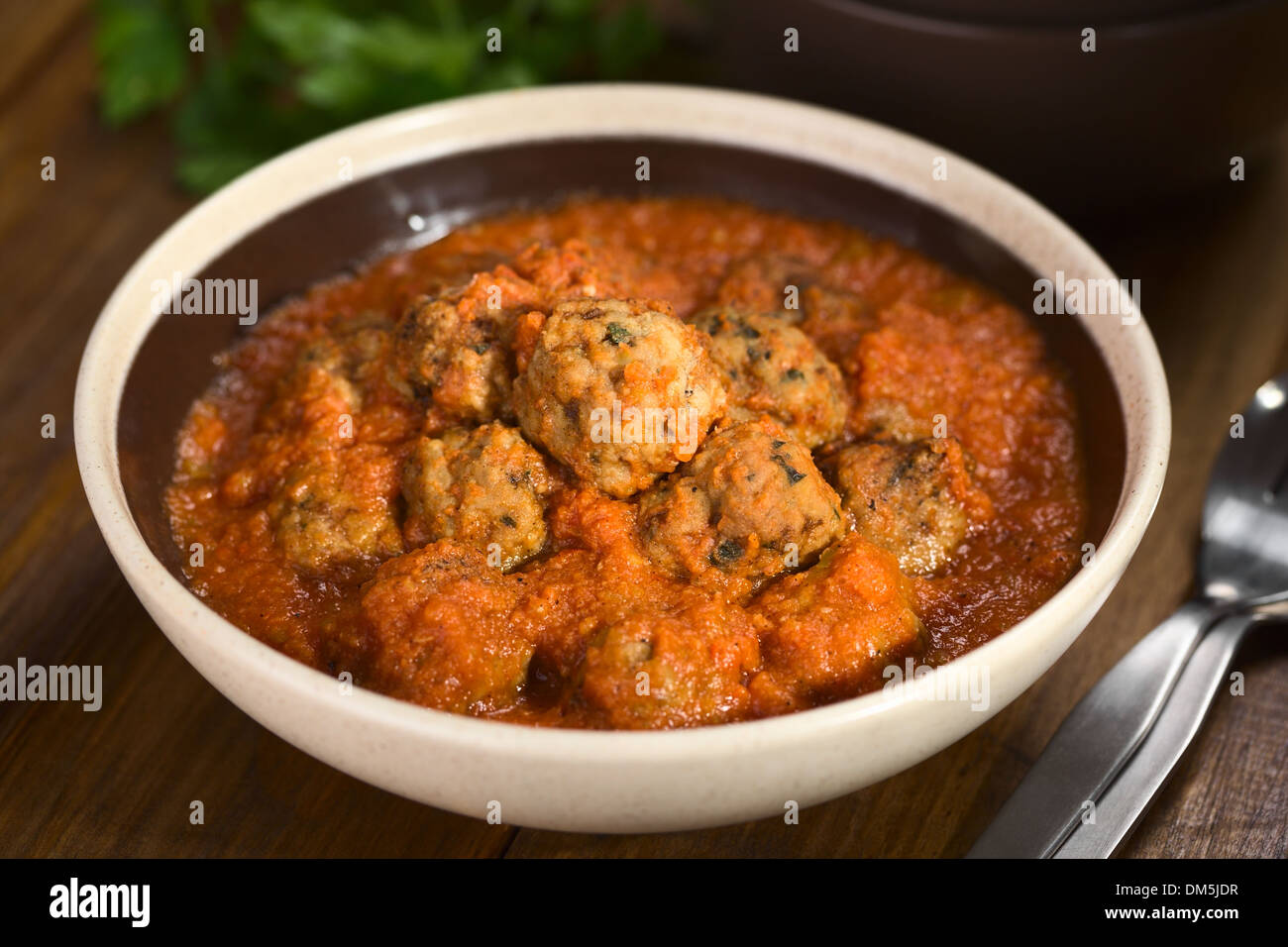 Spanish albondigas (meatballs) in tomato sauce in bowl (Selective Focus, Focus on the meatball on the top) Stock Photo