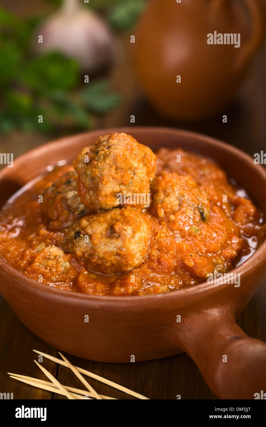 Spanish albondigas (meatballs) in tomato sauce in rustic bowl with toothpick in the front Stock Photo