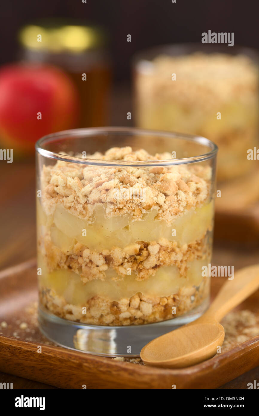 Simple no-bake Danish apple cake called Aeblekage made of stewed apple and vanilla cookie crumbs served in glass Stock Photo