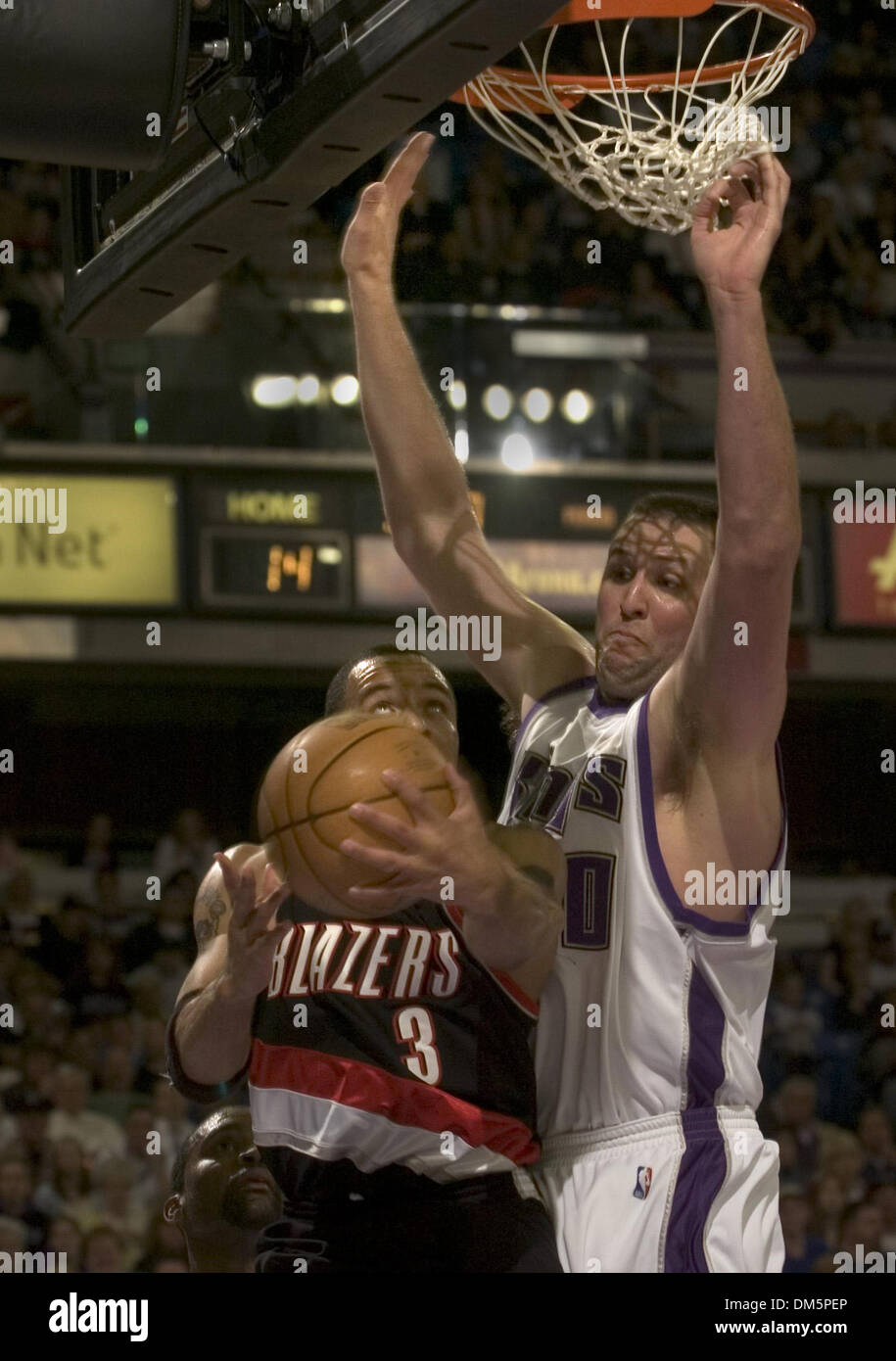 Mar 22, 2005; Sacramento, CA, USA; Sacramento Kings center Greg Ostertag attempts to block a shot by Damon Stoudamire of the Portland Trailblazers during the second quarter of their game at Arco Arena. The Kings won 112-93. Stock Photo