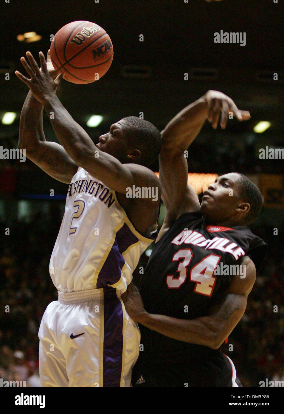 Mar 24, 2005; Albuquerque, NM, USA; University of Washington's Nate Robinson (02) gets fouled by University of Louisville's Larry O'Bannon in the second half of their NCAA Albuquerque Regional semifinal game in Albuquerque, New Mexico on Thursday, Mar 24, 2005. Stock Photo