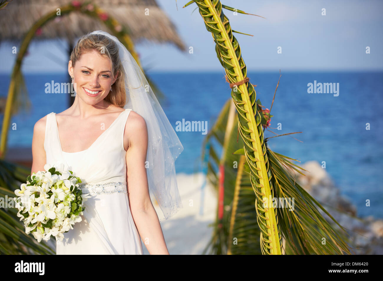 Beautiful Bride Getting Married In Beach Ceremony Stock Photo