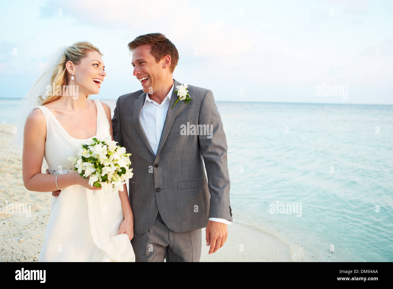 Bride And Groom Getting Married In Beach Ceremony Stock Photo