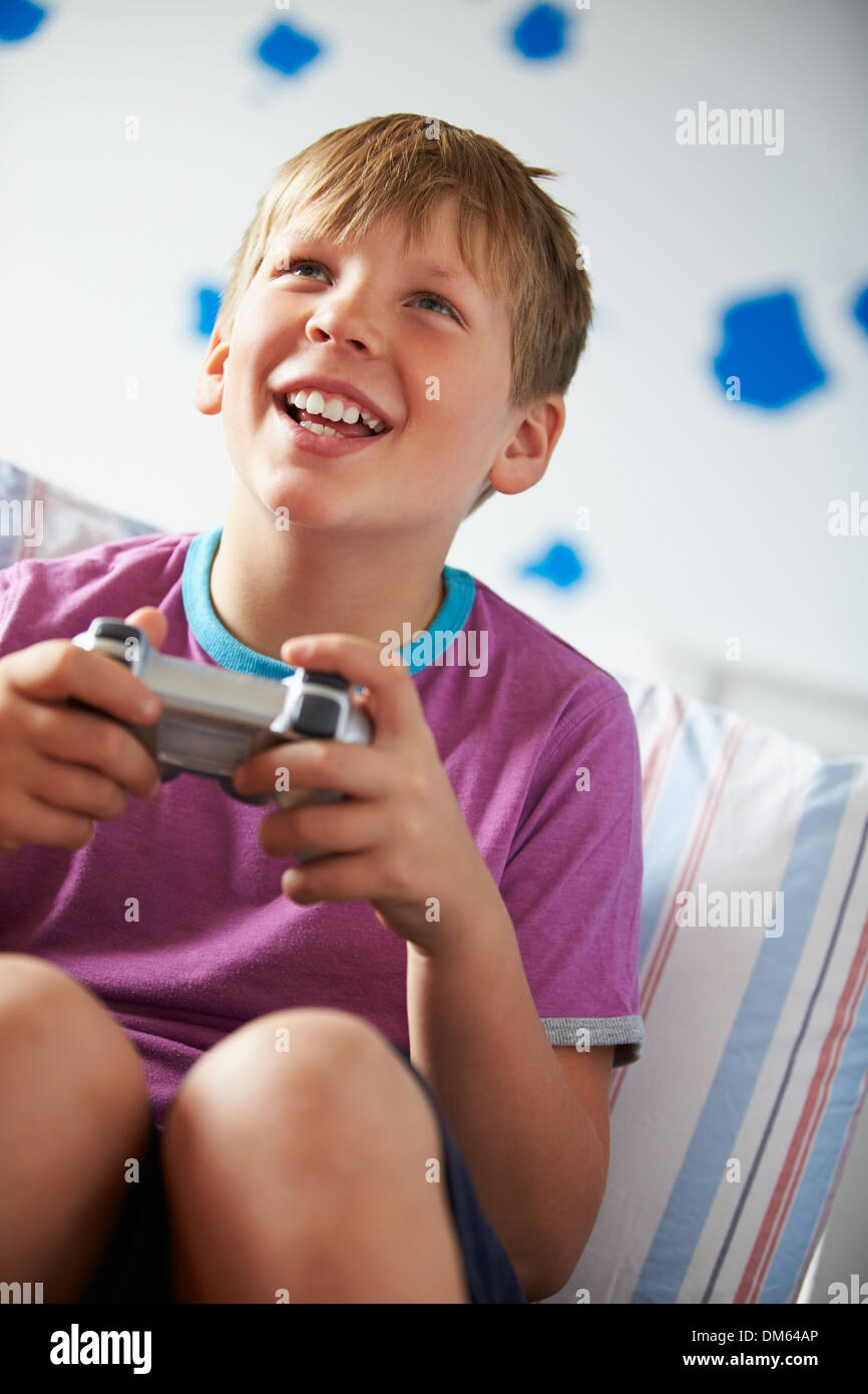 Boy Holding Controller Playing Video Game Stock Photo