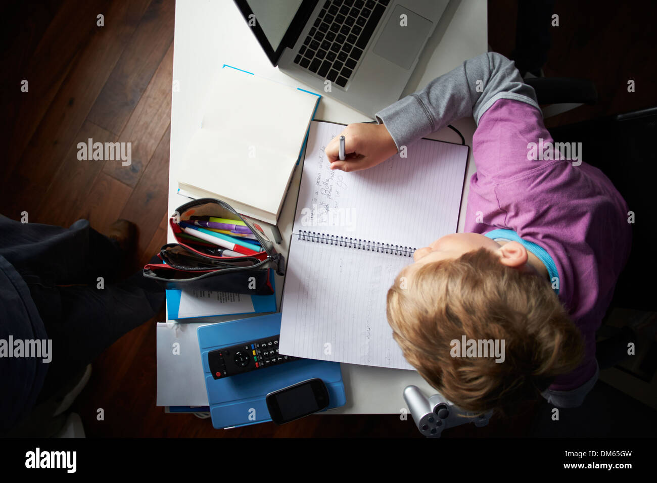 Overhead View Of Boy Studying In Bedroom Stock Photo