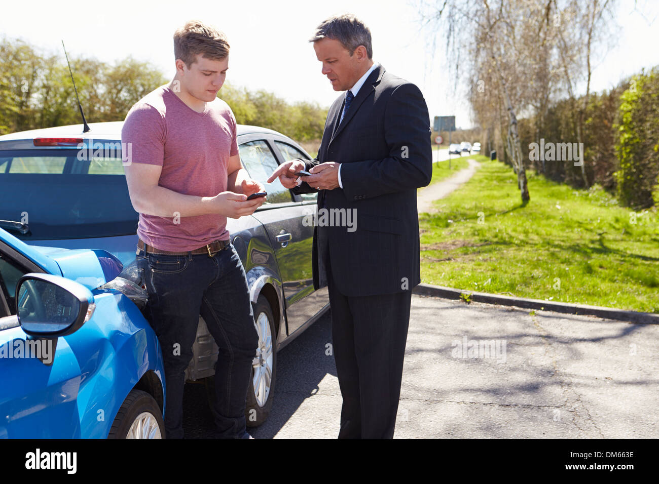 Two Drivers Exchange Insurance Details After Accident Stock Photo