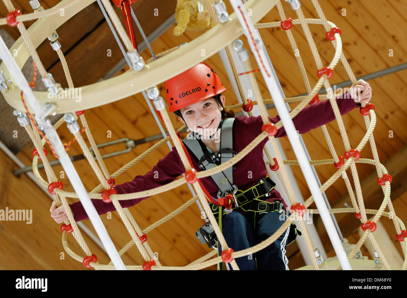 Girl on an indoor high rope-course in a Salewa Outlet Shop in Füssen, Bavaria, Germany Stock Photo