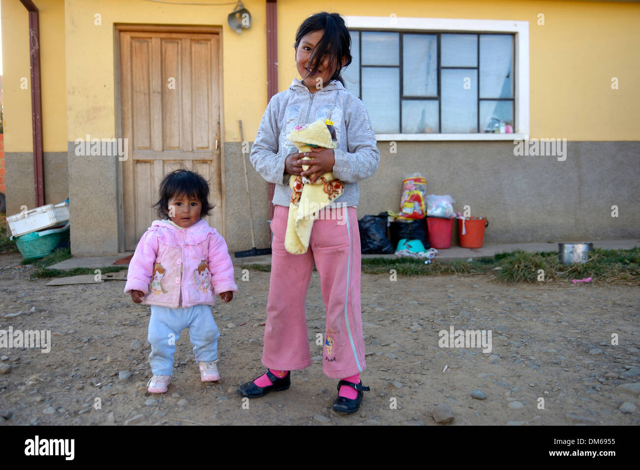 Two girls standing in front of a house, El Alto, Department of La Paz, Bolivia Stock Photo