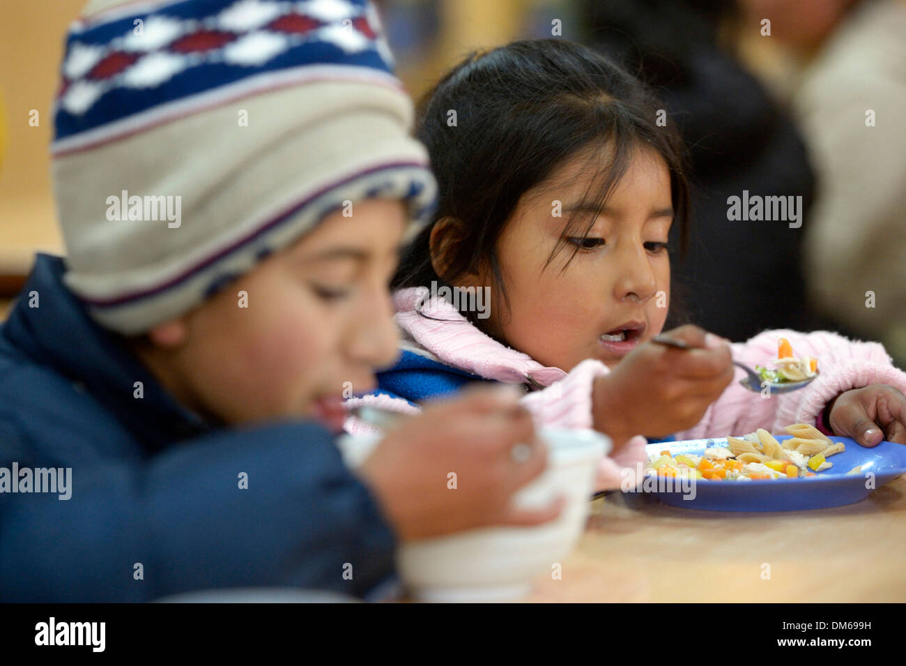 Children eating in the cafeteria of their school, El Alto, Department of La Paz, Bolivia Stock Photo
