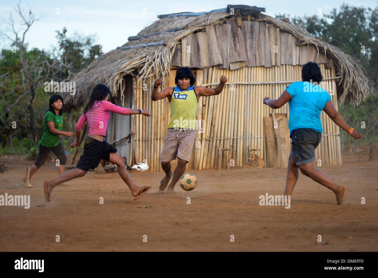 Youngers of the indigenous Xavante people playing football, village of Tres Rios near Sangradouro, Primavera do Leste Stock Photo