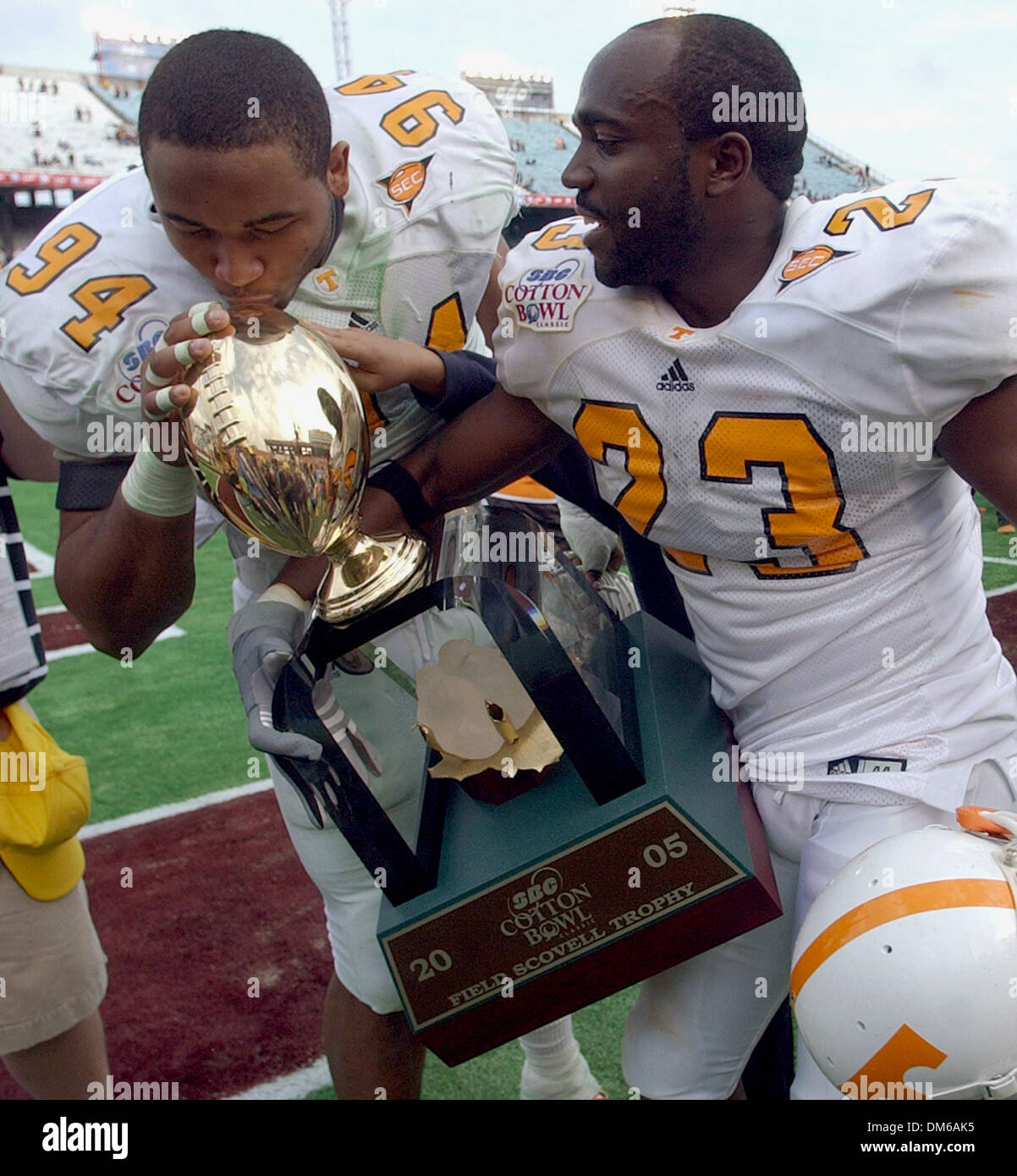 Jan 01, 2005; Dallas, TX, USA; NCAA College Basketball - (Tennessee 38, Texas A&M 7)Tennessee's Jason Hall kisses the Field Scovell Trophy as teammate Corey Larkins holds it after defeating Texas A&M 38-7  at the Cotton Bowl in Dallas, Tx. Stock Photo