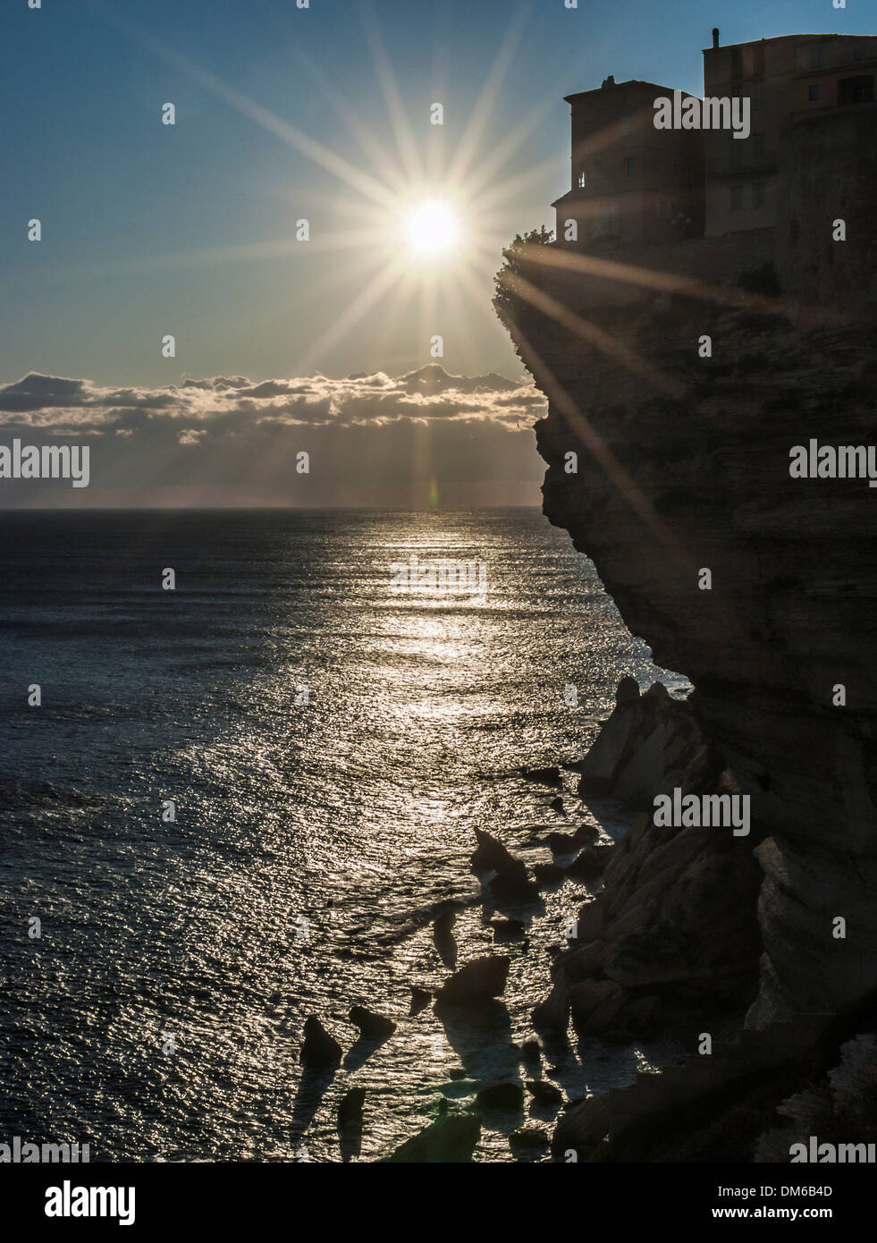 Sun over the Mediterranean Sea, cliffs with houses, backlit, Bonifacio, Corsica, France Stock Photo