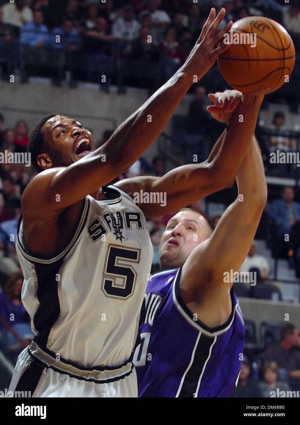 Jan 27, 2005; San Antonio, TX, USA; ROBERT HORRY is fouled by GREG OSTERTAG on a shot in the first half of the game at the SBC Center. San Antonio won 90-80. Stock Photo