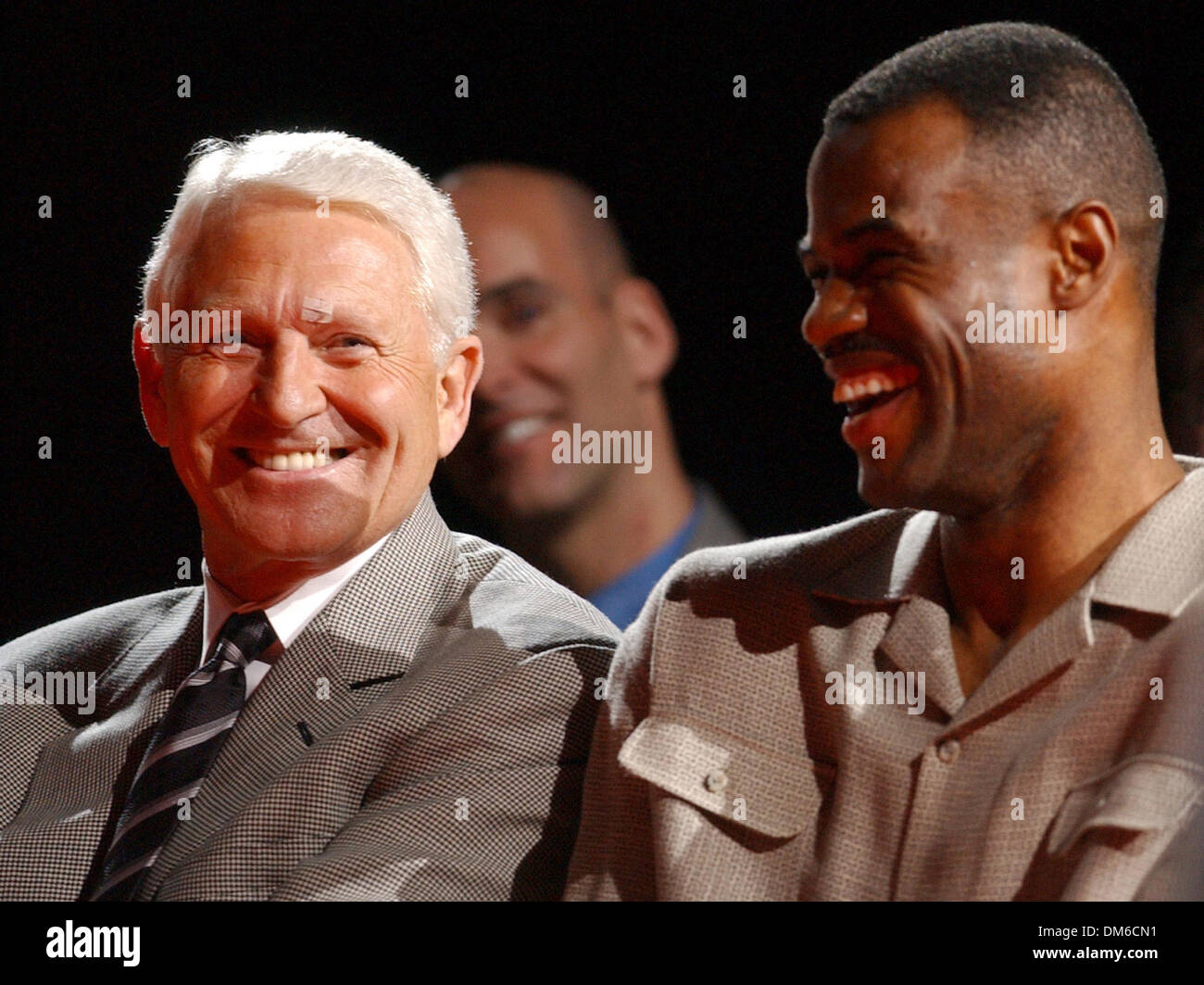 Mar 06, 2005; San Antonio, TX, USA; Arizona coach LUTE OLSON laughs with former Spurs' player DAVID ROBINSON during the retirement of Sean Elliott's jersey at the SBC Center. Stock Photo