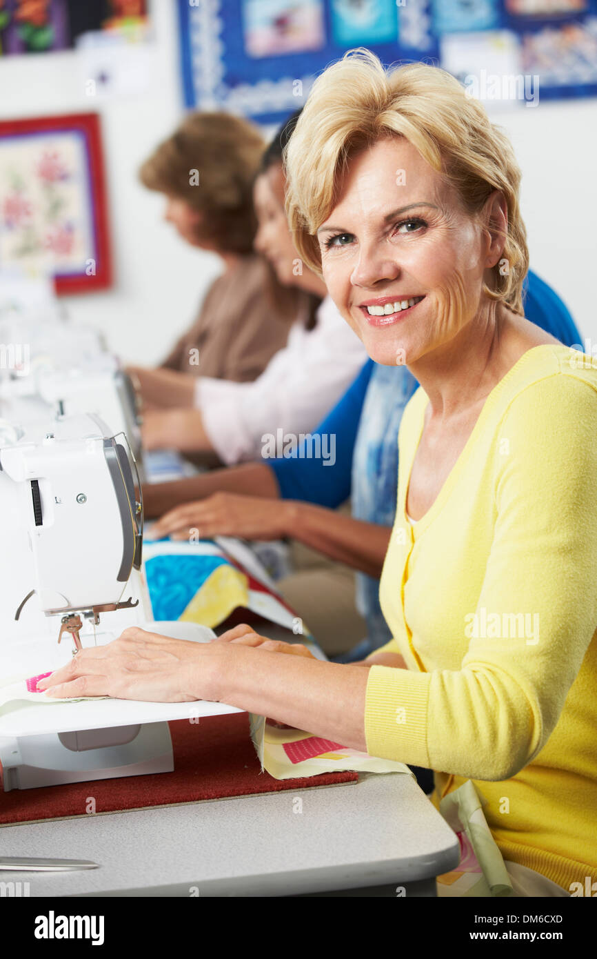Group Of Women Using Electric Sewing Machines In class Stock Photo Alamy