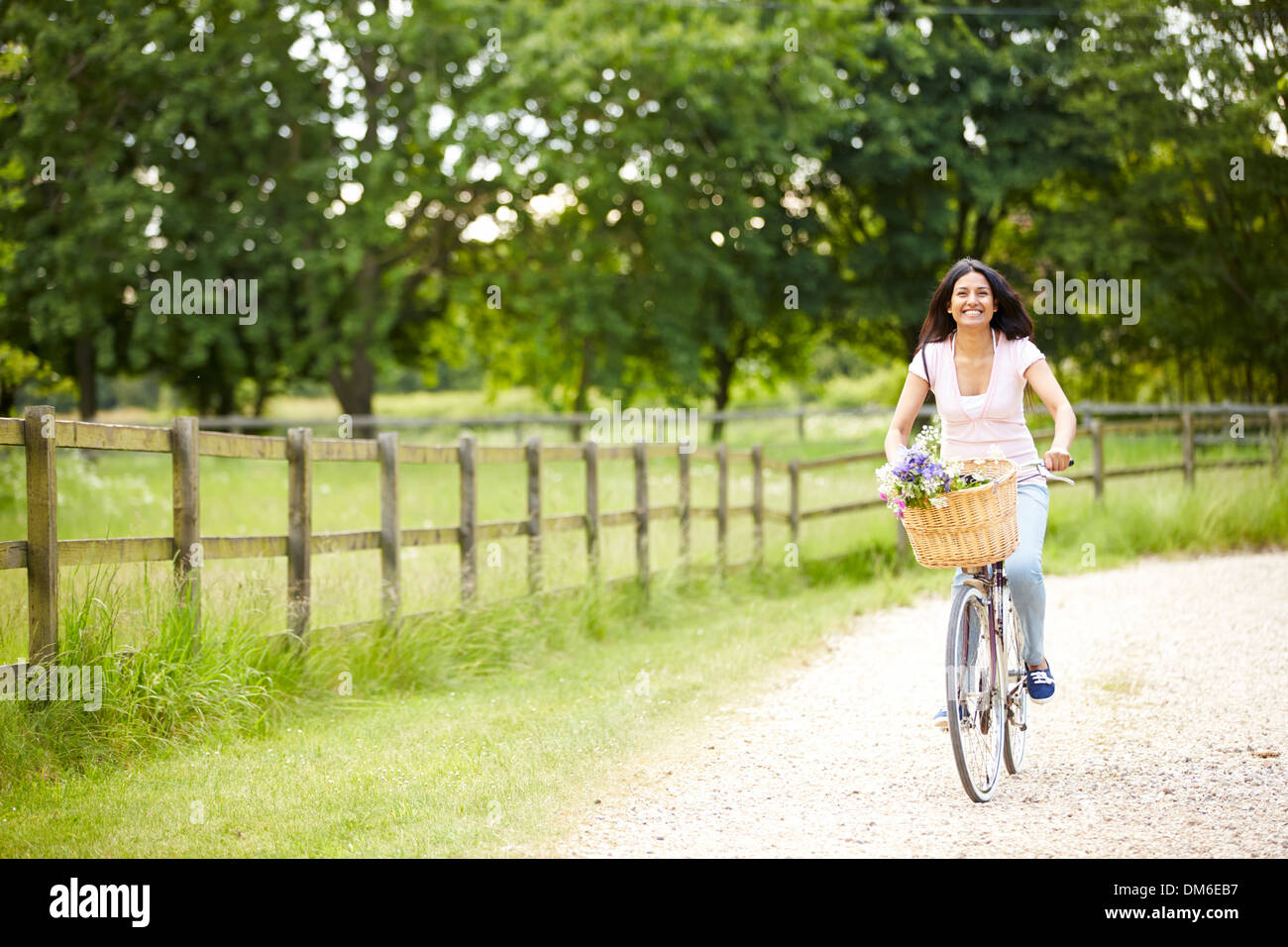 Indian Woman On Cycle Ride In Countryside Stock Photo