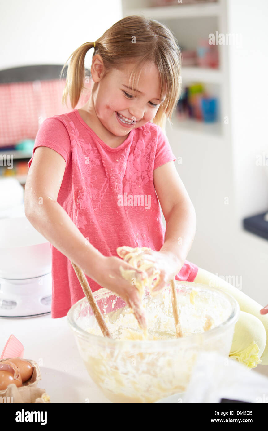 Girl Making Cupcakes In Kitchen Stock Photo