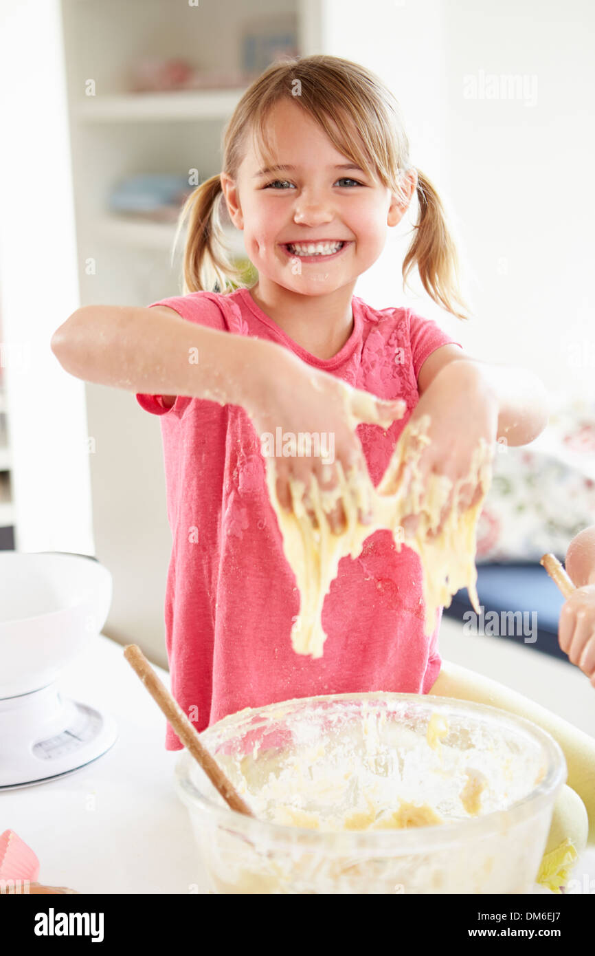 Girl Making Cupcakes In Kitchen Stock Photo
