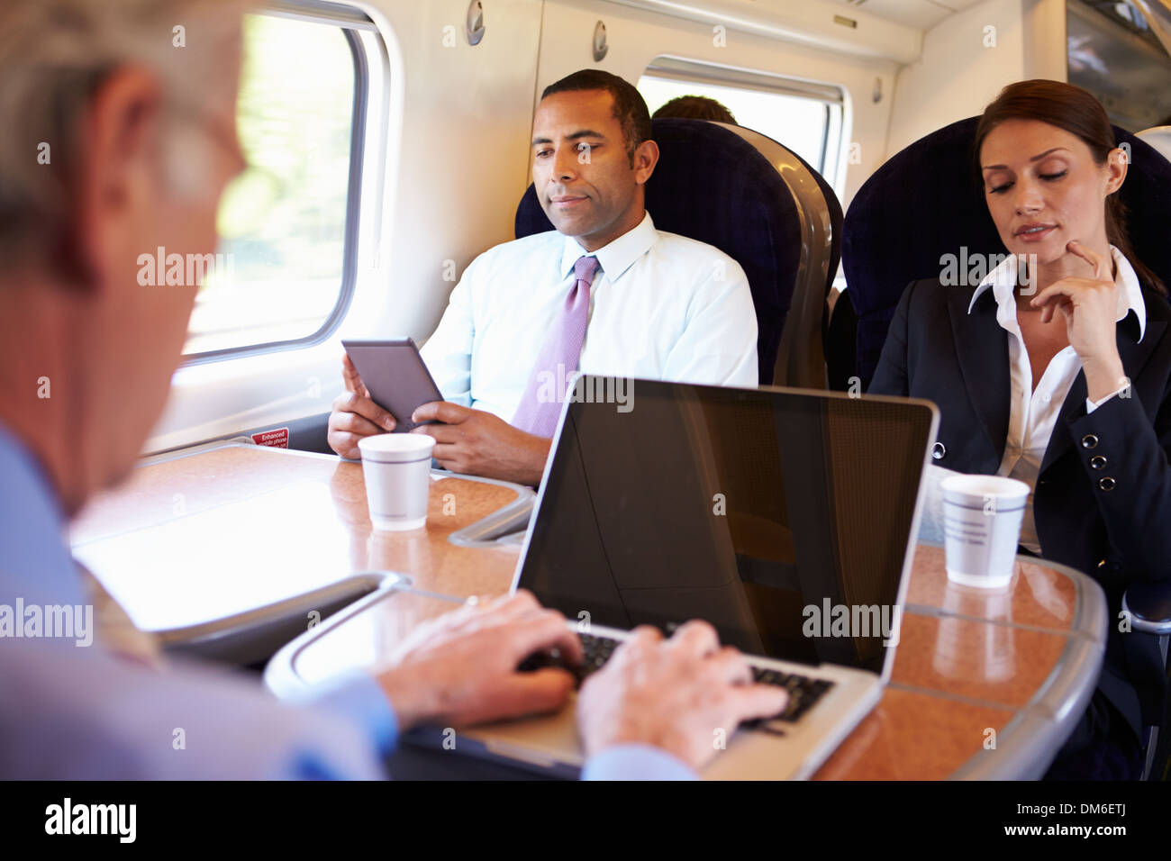 Businessman Commuting To Work On Train And Using Laptop Stock Photo Alamy