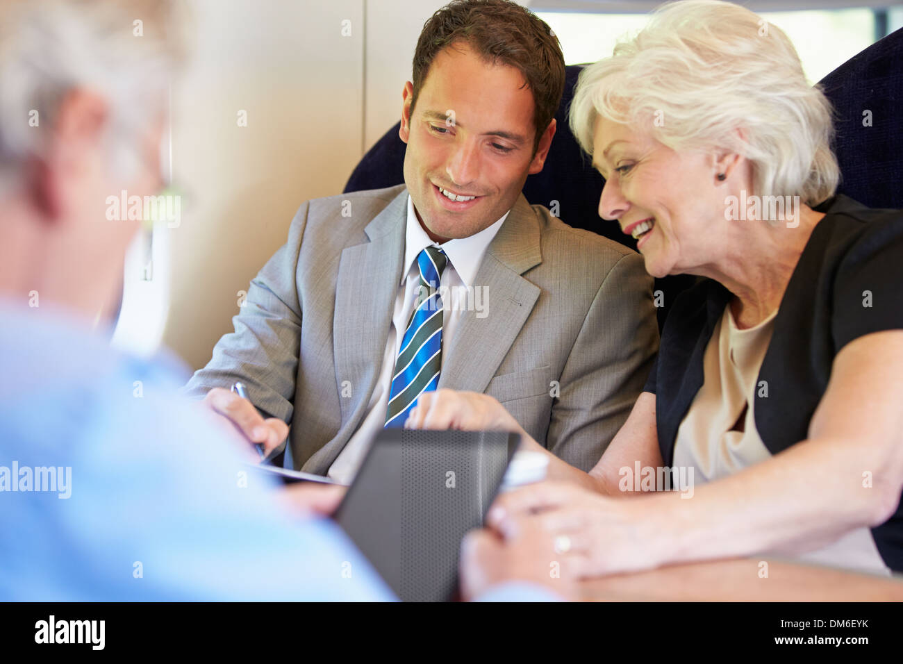 Businesspeople Having Meeting On Train Stock Photo