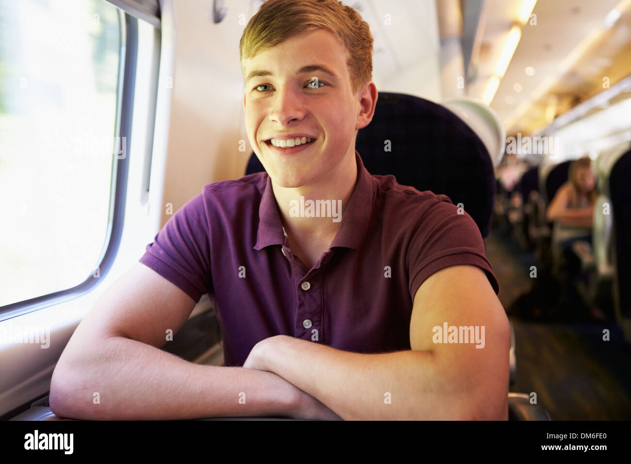 Young Man Relaxing On Train Journey Stock Photo