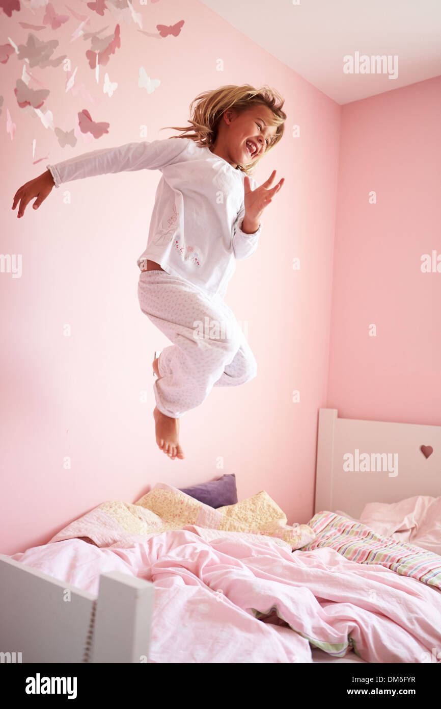 Young Girl Jumping On Her Bed Stock Photo Alamy