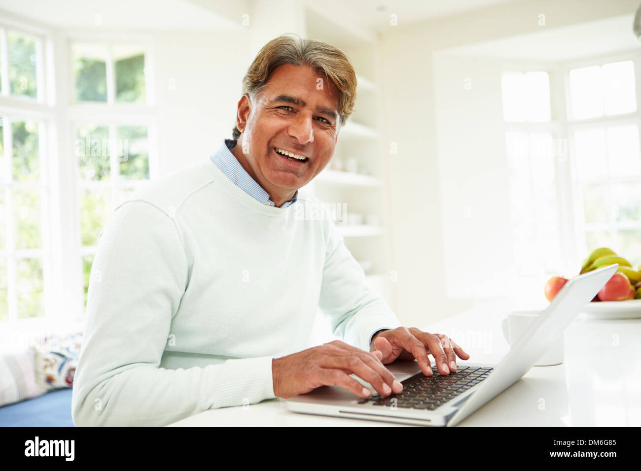 Senior Indian Man Using Laptop At Home Stock Photo