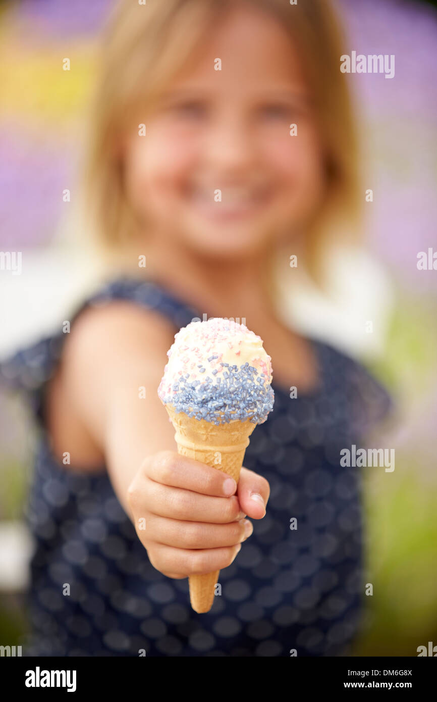Young Girl Eating Ice Cream Outdoors Stock Photo
