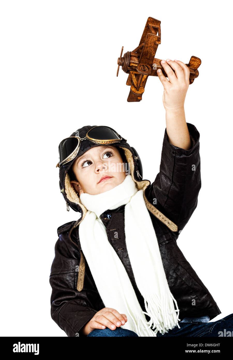 Happy cute boy dressed like a World War II pilot playing with wooden ...