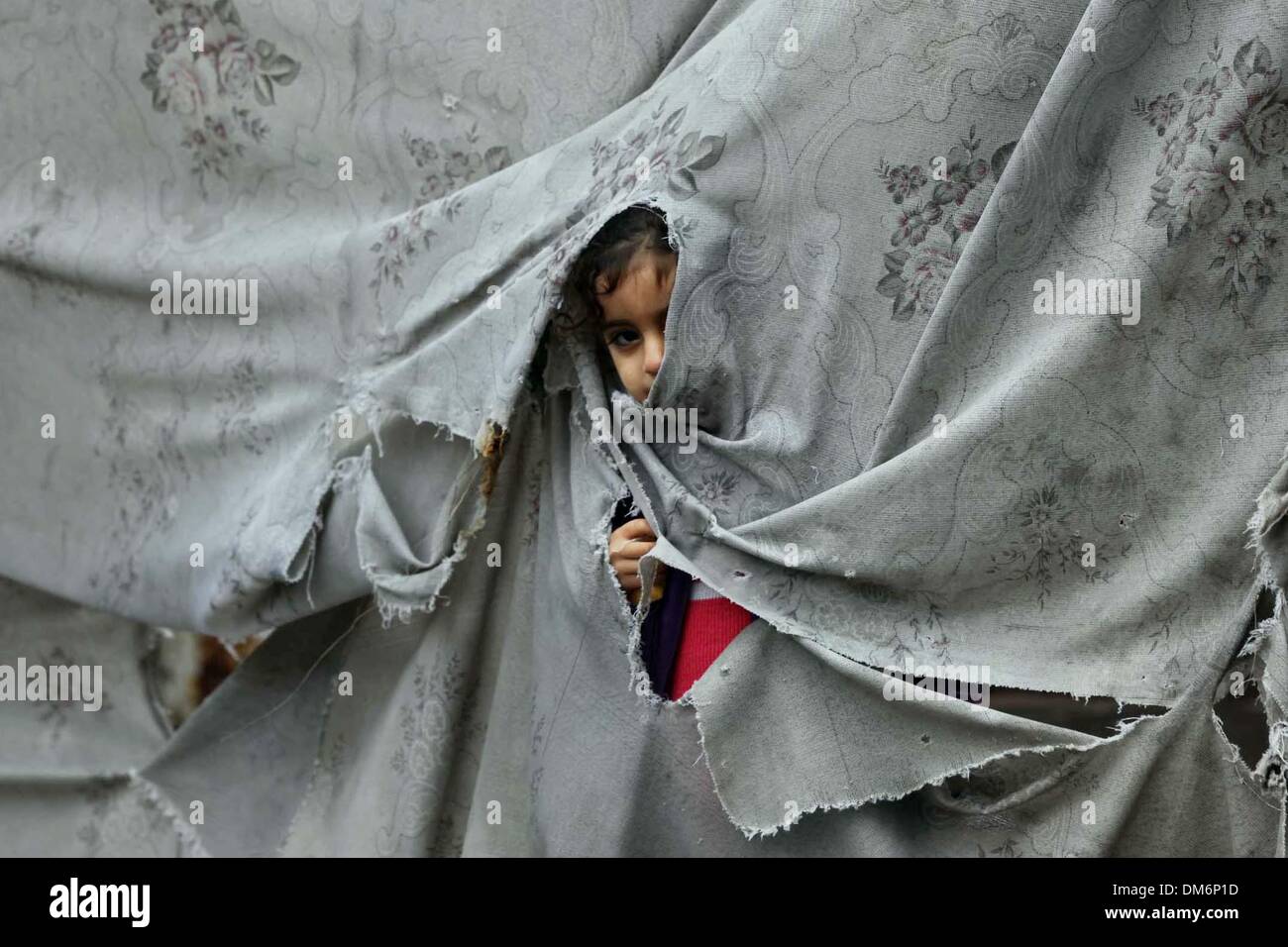 Gaza, Palestinian Territories. 12th Dec, 2013. A Palestinian girl plays ...